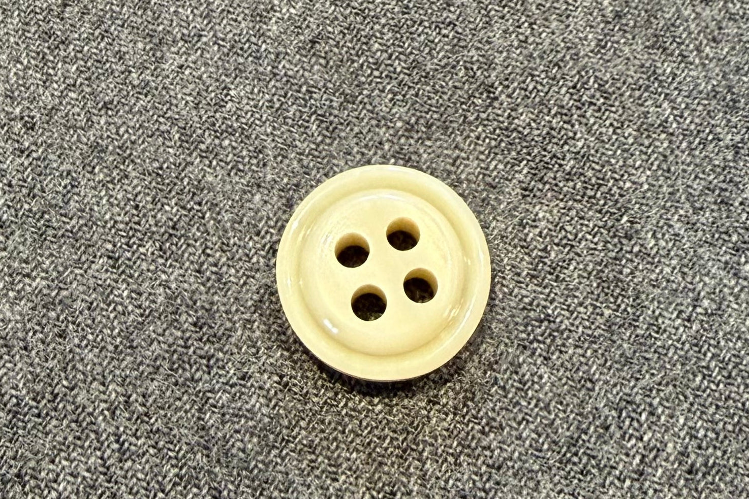 Button on a gray fabric surface