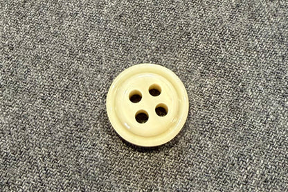 Button on a gray fabric surface