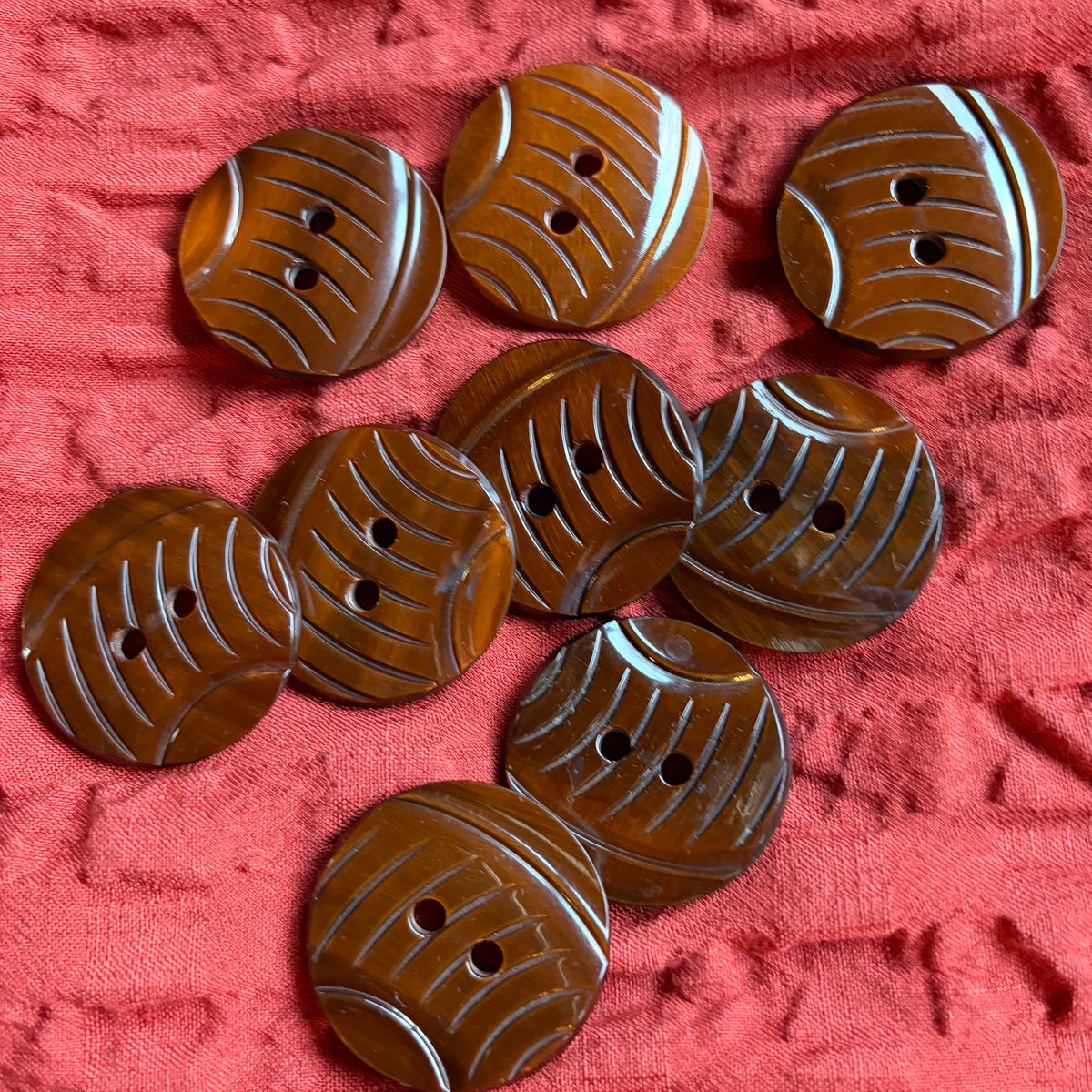 Detail of a carved brown casein shank button, 34 mm.