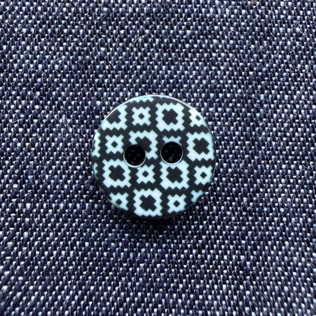 Whimsical patterned plastic shirt buttons in six prints on denim