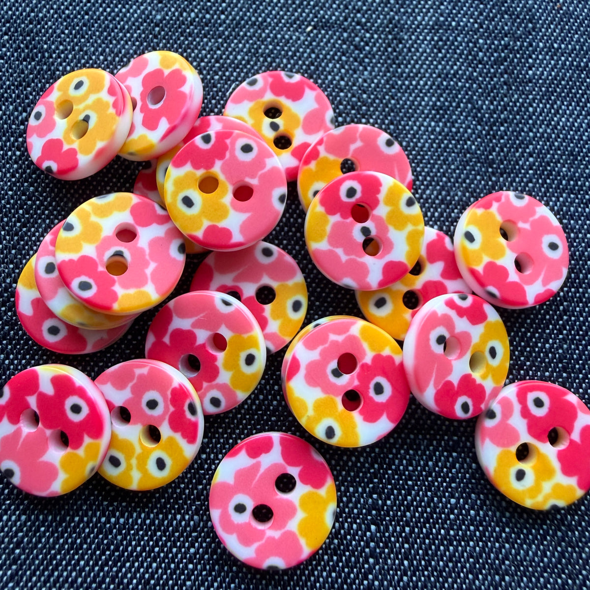 Whimsical patterned plastic shirt buttons in six prints on denim