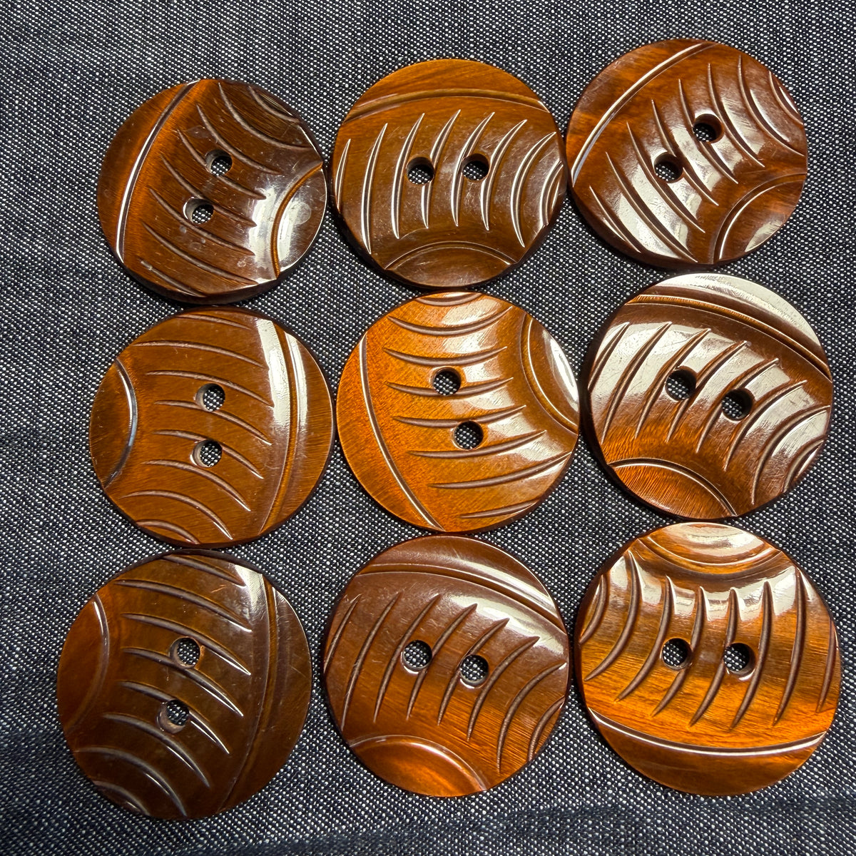 Carved brown casein shank button that looks like wood.