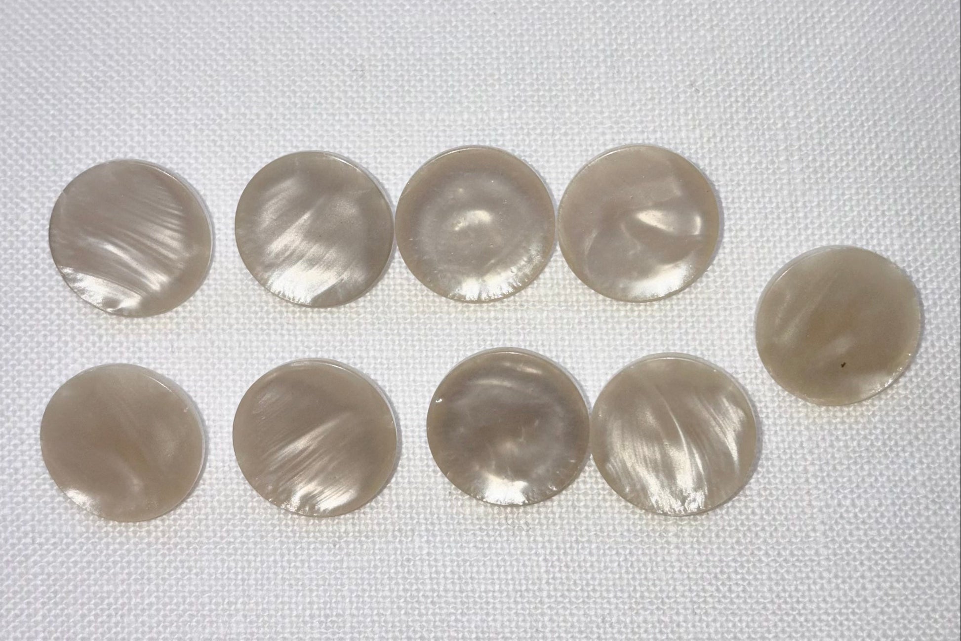 Set of round, white buttons on a white background