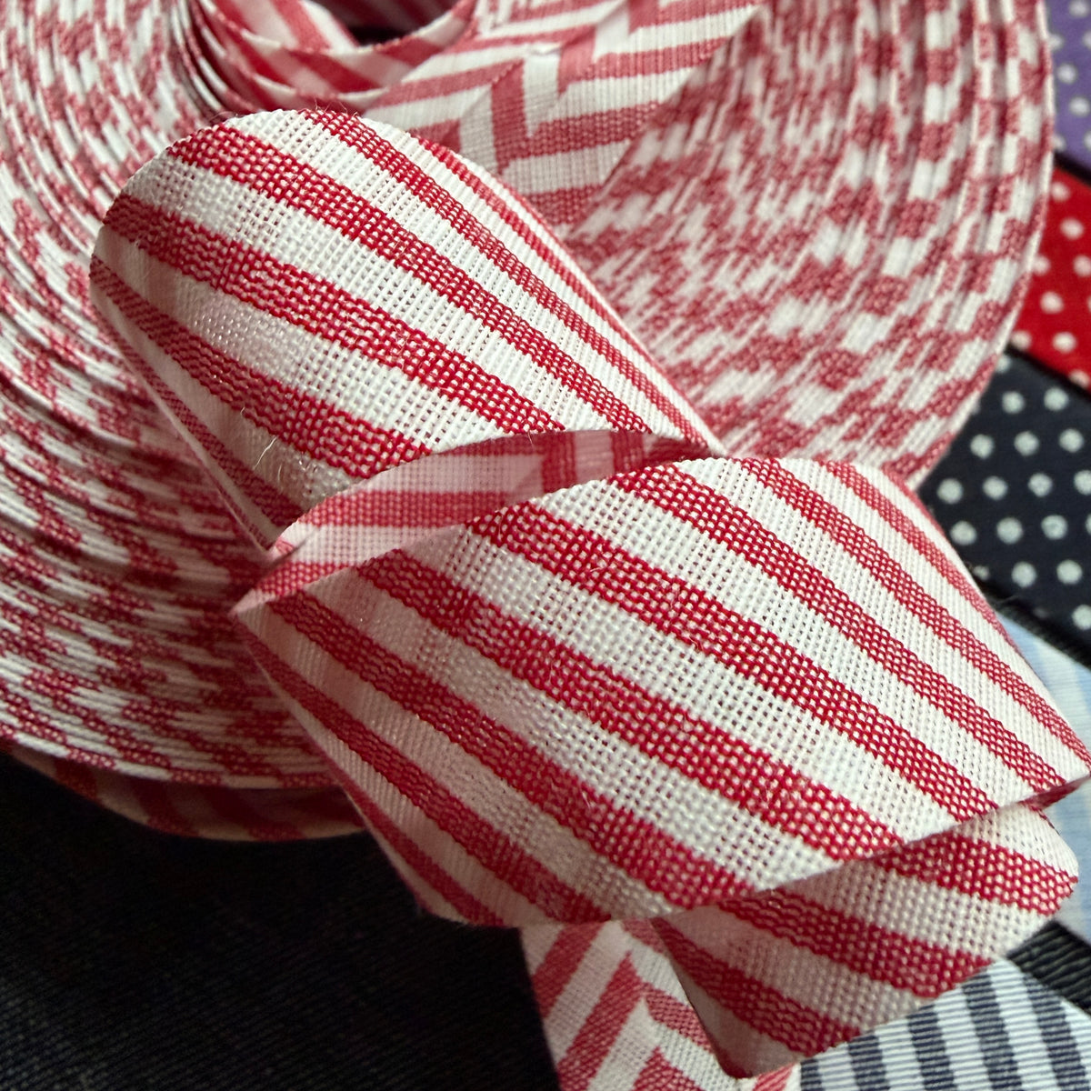 Red and white striped cotton bias tape on the roll