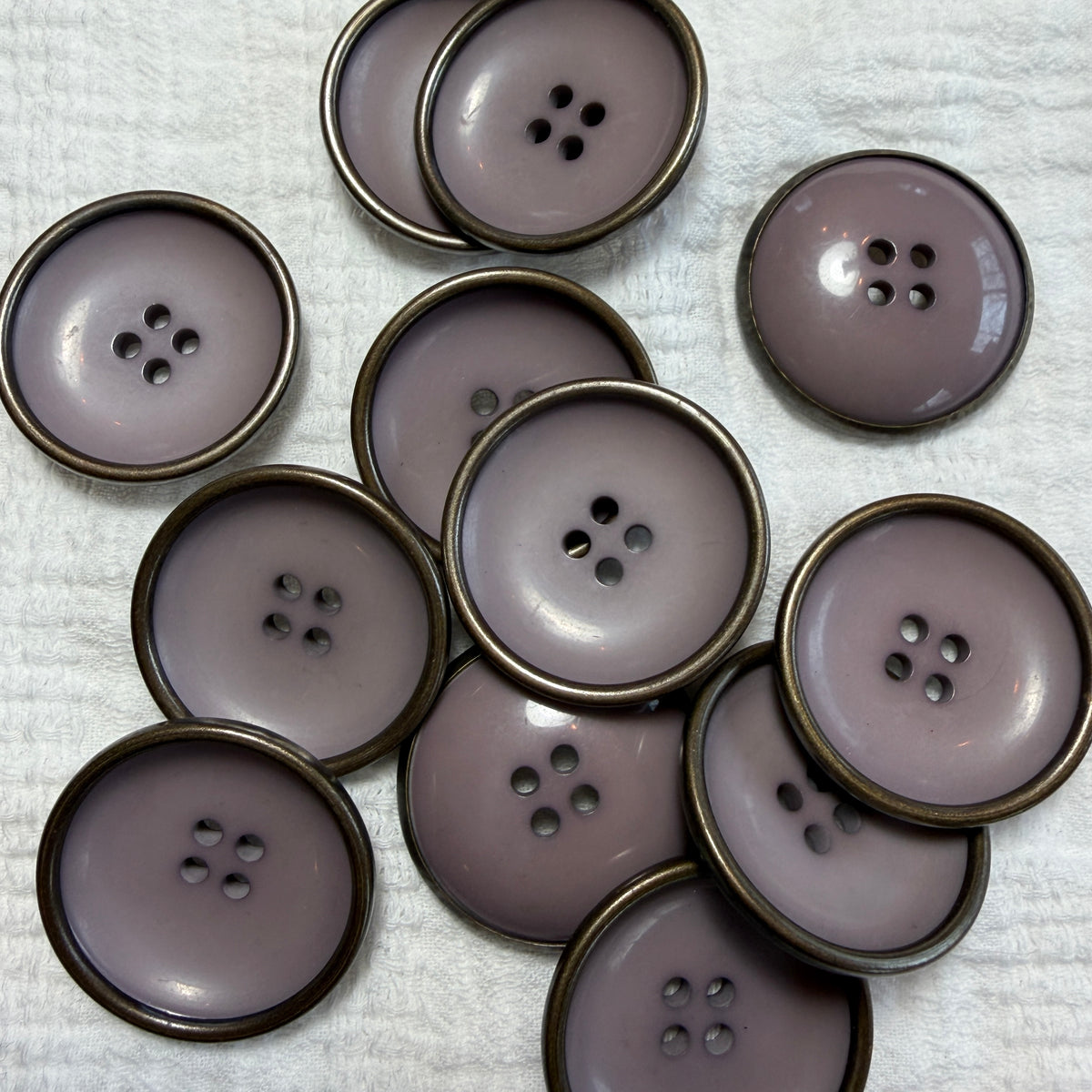 Mauve concave button with a metal rim, 28 mm.