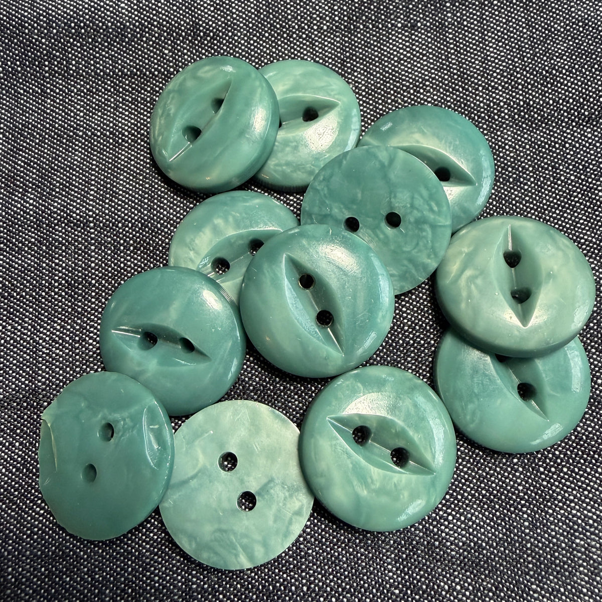 Polished teal casein fisheye buttons, 20 mm.
