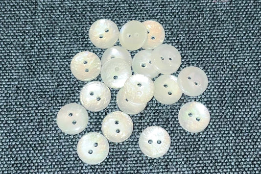 White buttons on a textured gray fabric background