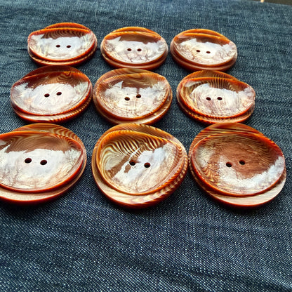 Rows of rust and copper two-hole statement buttons handmade in Argentina.