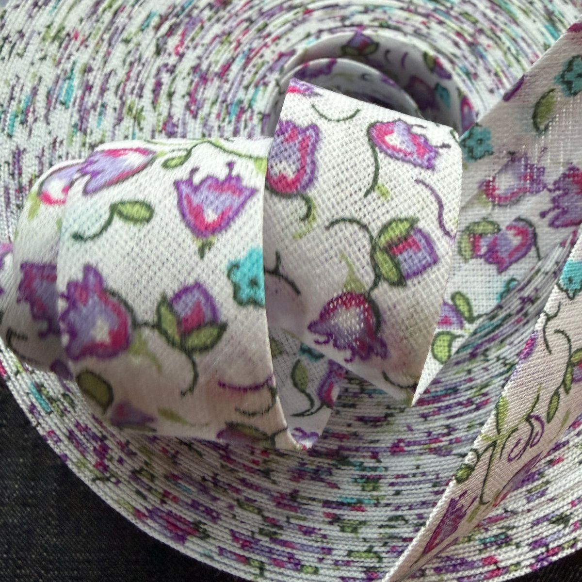 Purple floral cotton bias tape on the roll