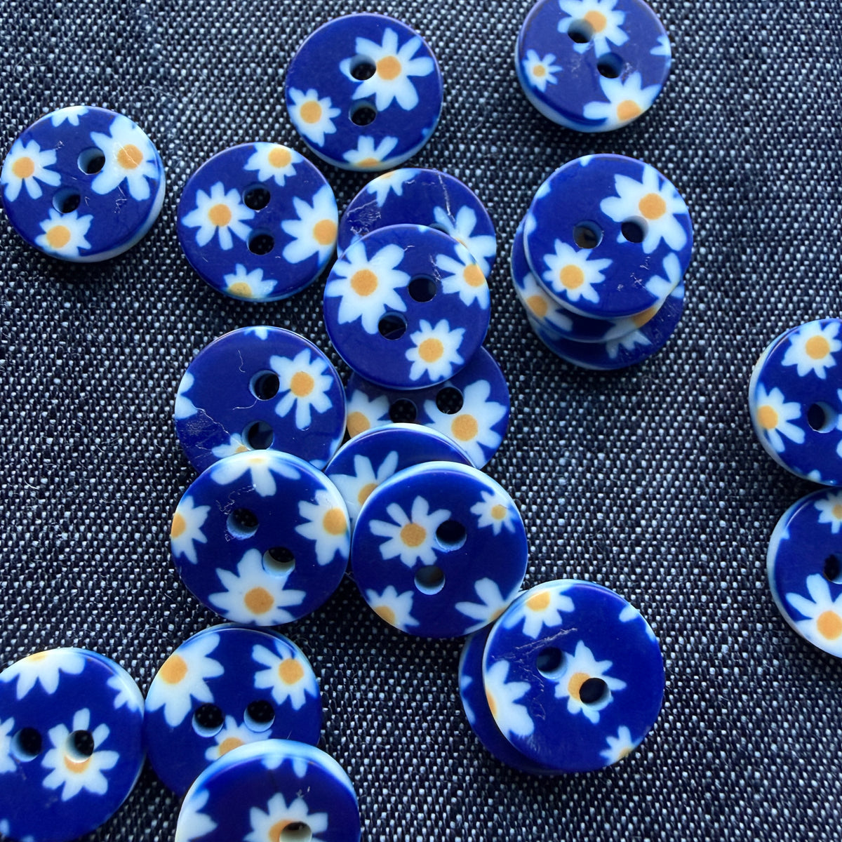 Whimsical patterned plastic shirt buttons in six prints on denim