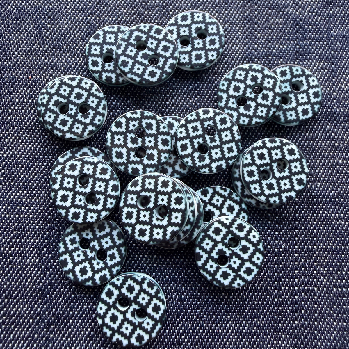 Whimsical patterned plastic shirt buttons in six prints on denim