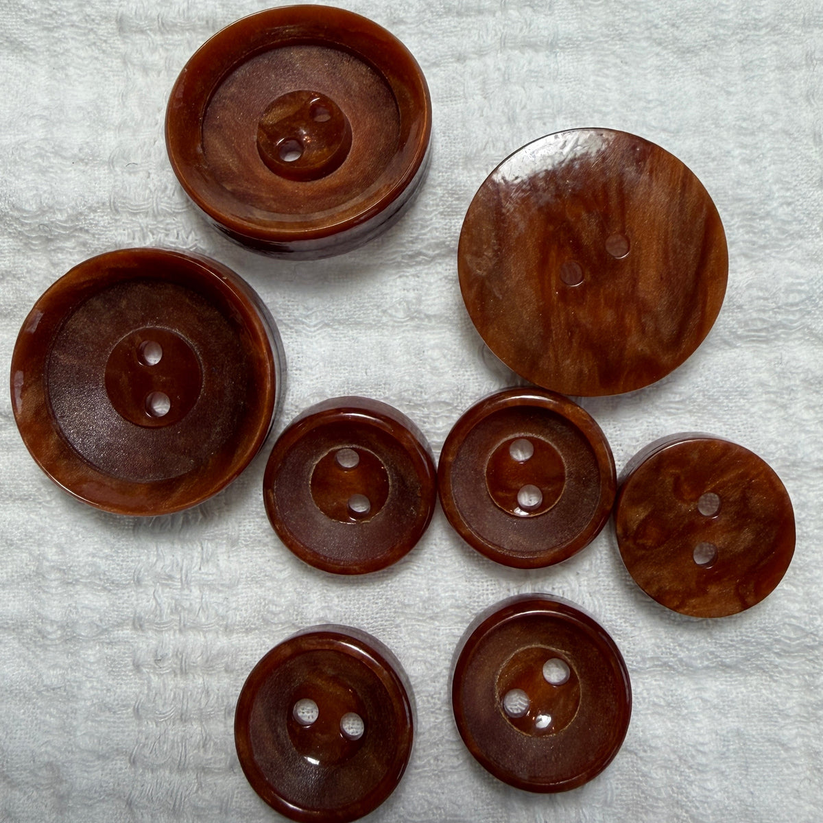Natural brown casein two-hole button, handmade in Argentina.