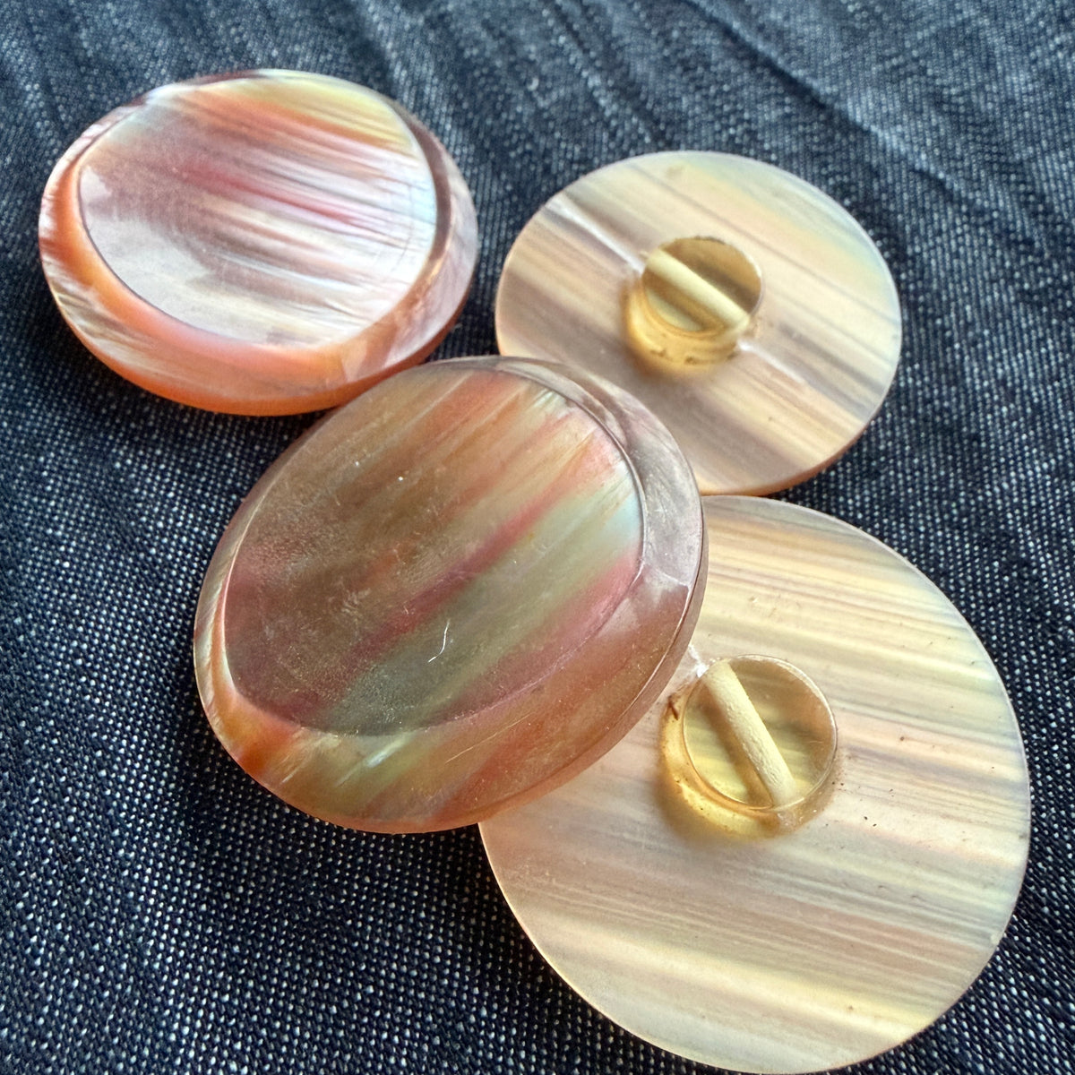 Rose-gold casein buttons shown front and back, with the shank visible.