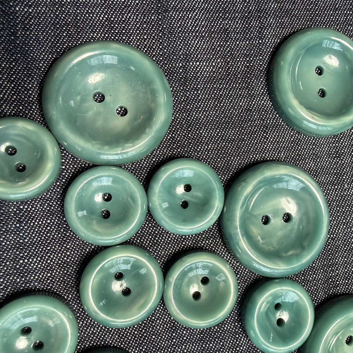 Detail of a natural teal casein concave button.