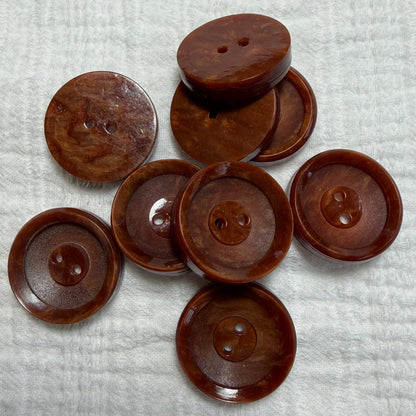 Natural brown casein two-hole buttons in 14 mm and 22 mm.