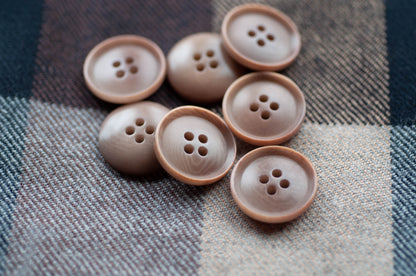 Brown buttons on a plaid fabric background