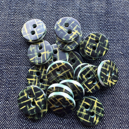 Whimsical patterned plastic shirt buttons in six prints on denim