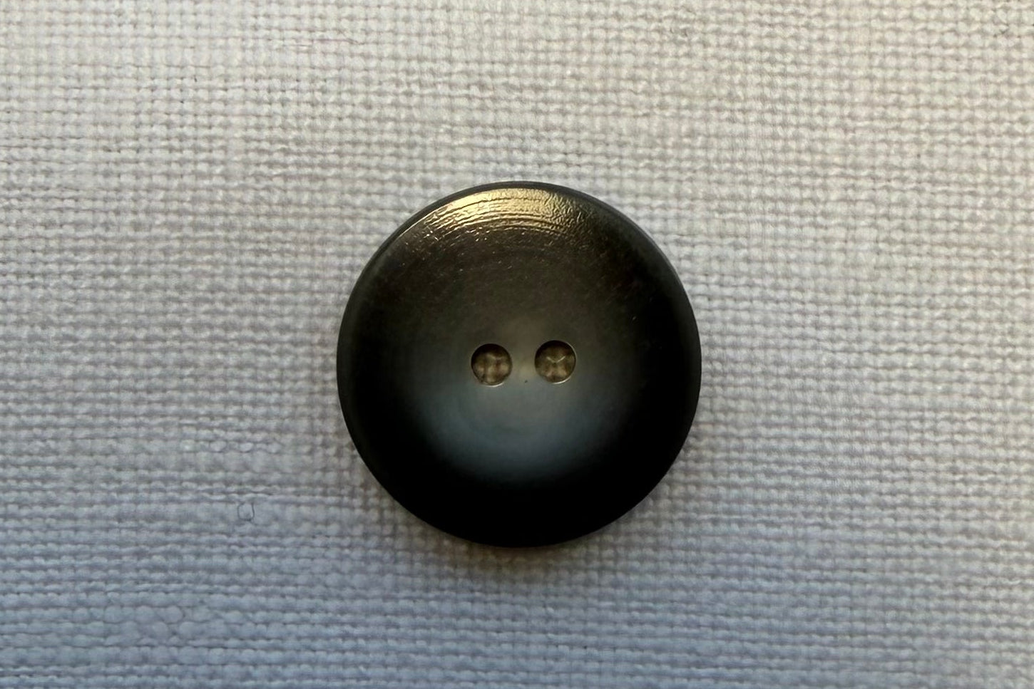 Grey button on a textured gray background