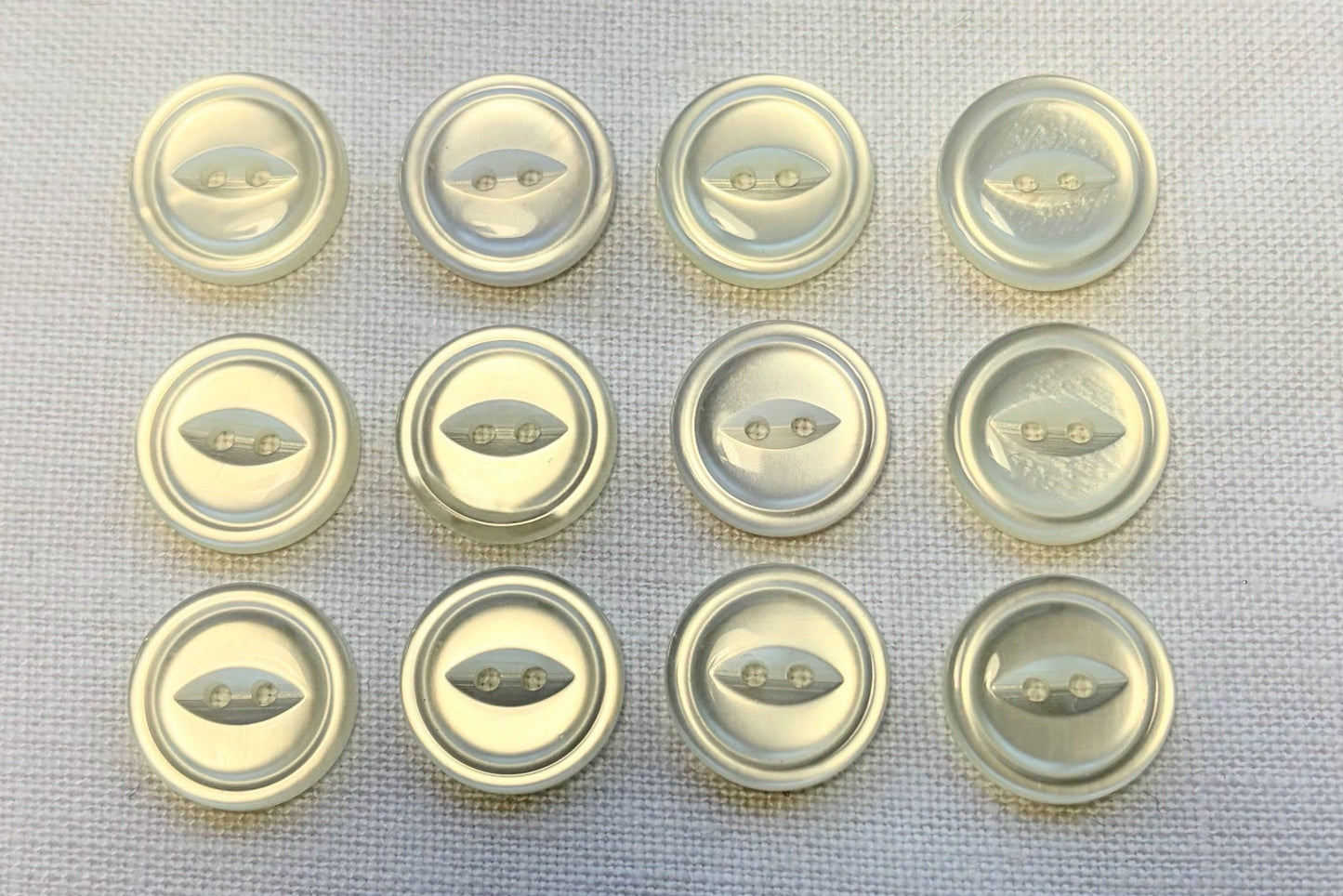 Set of white buttons on a textured surface