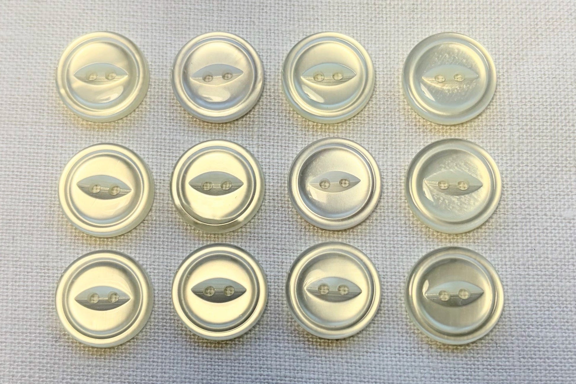 Set of white buttons on a textured surface