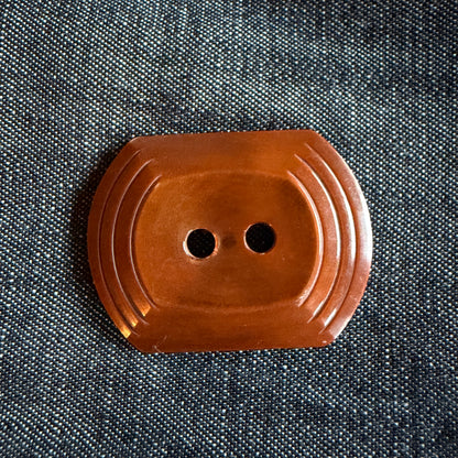 Natural brown oblong casein buttons with a tiered edge, 30 x 38 mm, handmade in Argentina.